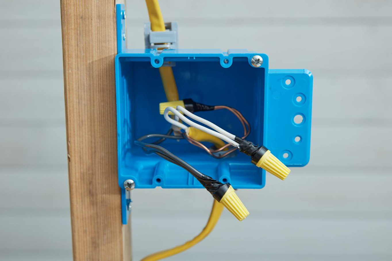 Romex Wiring should always be placed inside of an enclosed Junction box to avoid hazards like electric arcing, resulting in potential fire and electric shocks.